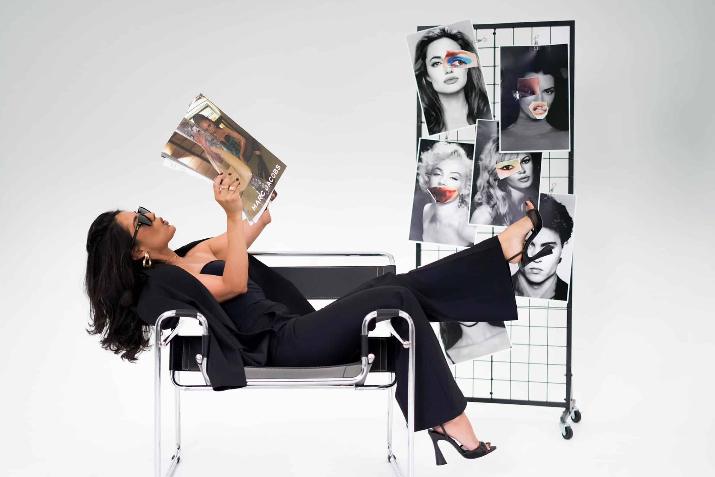 Model in black reclining on a directors chair during a shoot in a natural-light Miami studio