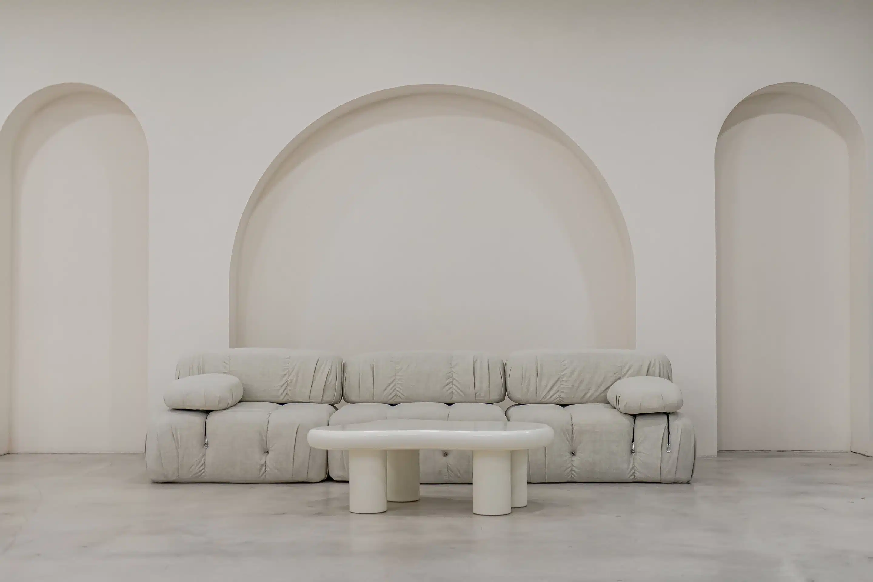 Boucle couch set against the arch wall in a private Miami photo studio