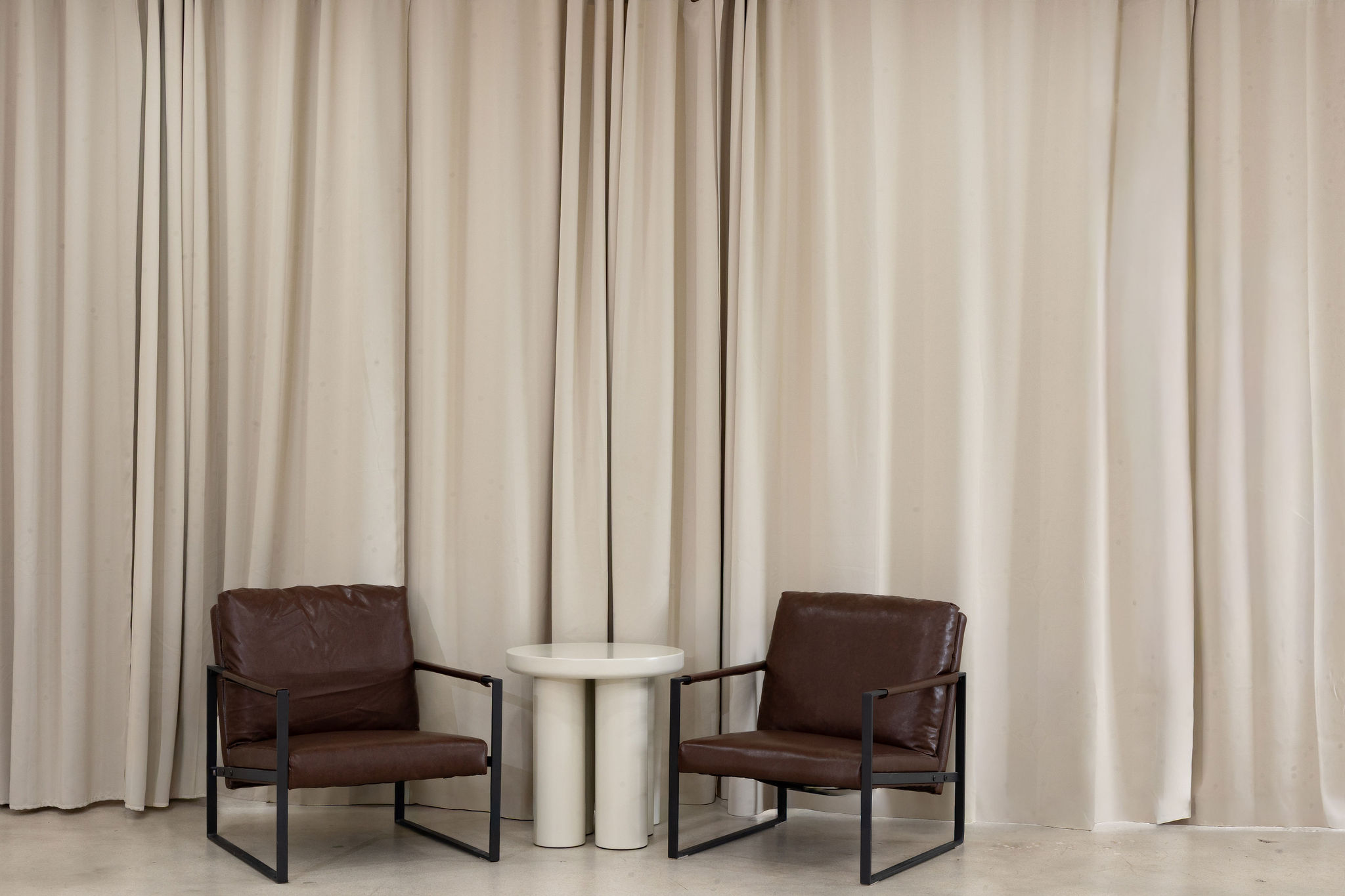 Natural-light sofa corner with sheer drapes in a spacious Miami photo studio