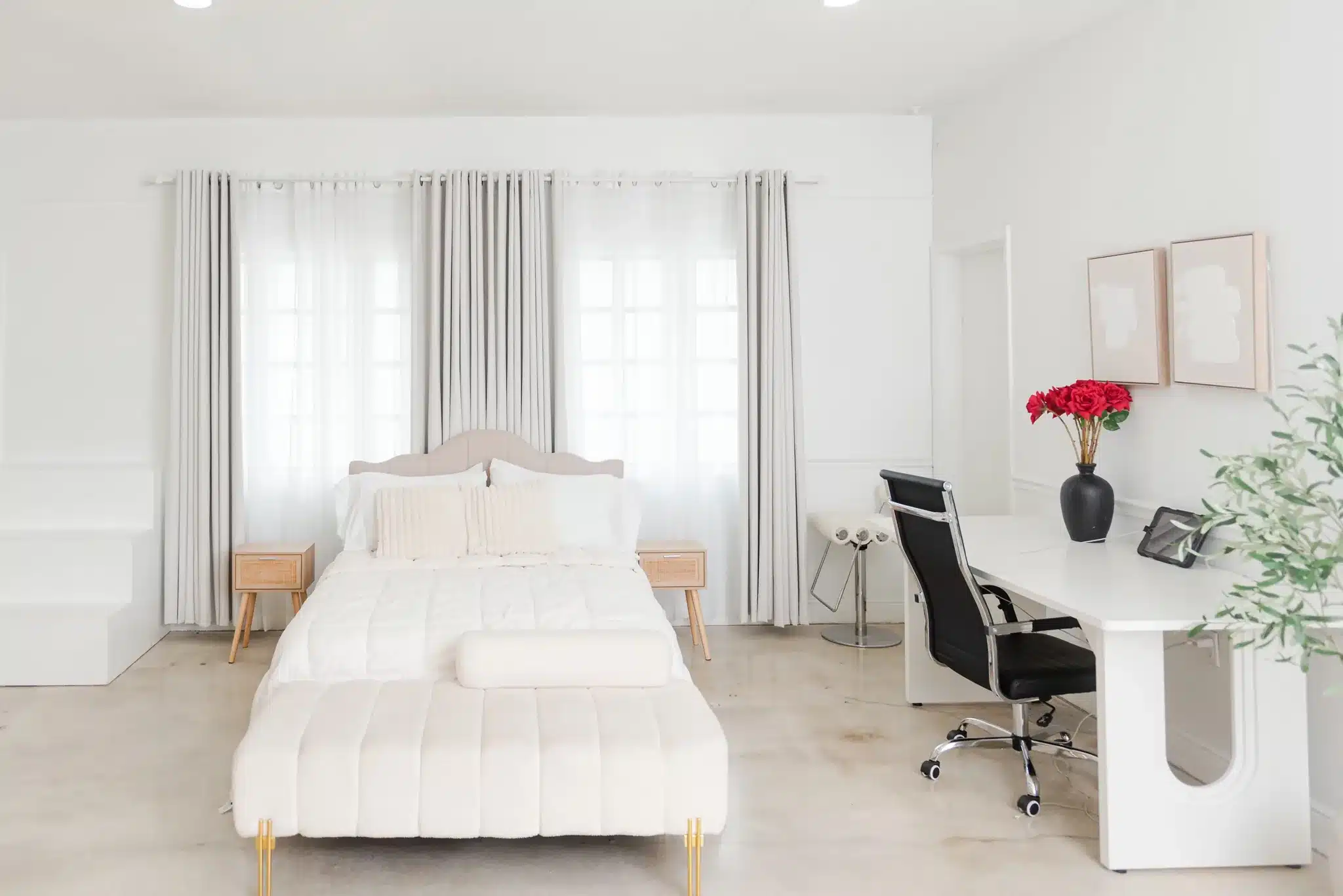 Bright all-white styled bedroom set with a desk workspace in a Miami photo studio